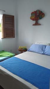 Ένα ή περισσότερα κρεβάτια σε δωμάτιο στο Recanto do Meu Bem