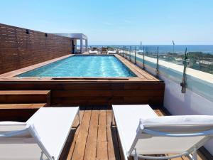a swimming pool on the roof of a building at Eurohotel Diagonal Port in Barcelona