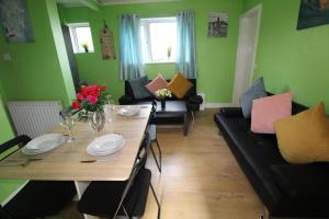 a living room with a table and a couch at Raynald House in Sheffield