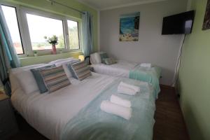 a hotel room with two beds with white pillows at Raynald House in Sheffield