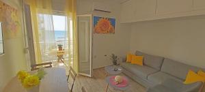 a living room with a couch and a table at Perea Silvi suite in Perea
