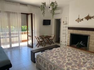 a living room with a bed and a fireplace at B&B Tra Mare e Marmo in Marina di Carrara