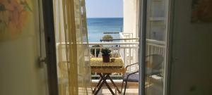 a balcony with a table and a view of the ocean at Perea Silvi suite in Perea