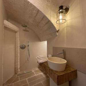 a bathroom with a sink and a shower at Caterina's Suites & Apartament in Ostuni