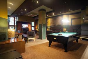 a living room with a pool table and chairs at Hotel Igartza in Beasain