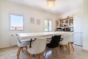 a kitchen with a large wooden table and chairs at El Nido in Manzanares el Real