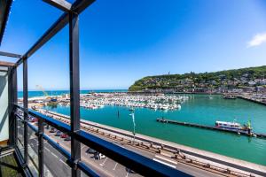 a view of a marina with boats in the water at Hotel Le Grand Pavois in Fécamp
