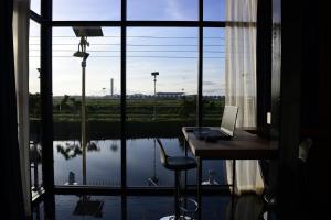 a laptop computer sitting on a desk in front of a window at Skyline Resort in Ban Khlong Lat Bua Khao
