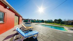 a pair of lounge chairs sitting next to a swimming pool at Refined Villa near Catanhede with Private Pool in Cantanhede