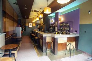 a bar in a restaurant with tables and chairs at Hotel Igartza in Beasain