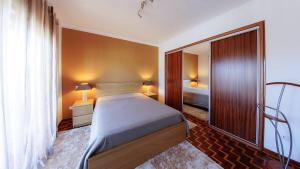 a small bedroom with a bed and a mirror at Refined Villa near Catanhede with Private Pool in Cantanhede +42 photos