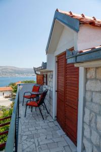 a balcony with two chairs and a table on it at A2 - studio with balcony just 3 min to the beach in Okrug Donji