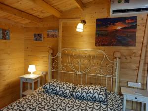 a bedroom with a bed in a wooden cabin at Cyprus Glamping Park in Ayios Theodhoros