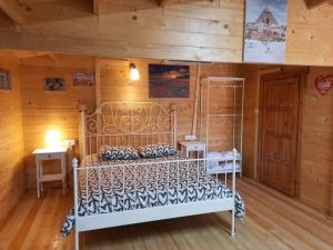 a bedroom with a bed in a room with wooden walls at Cyprus Glamping Park in Ayios Theodhoros