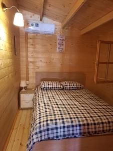 a bedroom with a bed in a wooden cabin at Cyprus Glamping Park in Ayios Theodhoros