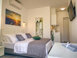 Postel nebo postele na pokoji v ubytování SmartMini Apartments