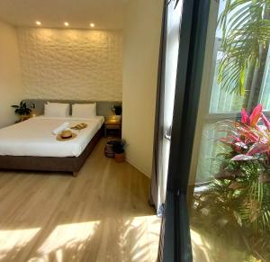 
a bedroom with a white bed and white walls at Adonis Cupecoy in Cupecoy
