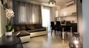 a living room with a couch and a dining room at Haus Viktoria 3 in Limenas