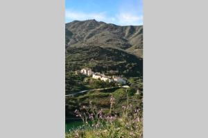 a view of a mountain with a village on a hill at Cortijo tranquilo, Albanchez, Almeria Province in Albánchez
