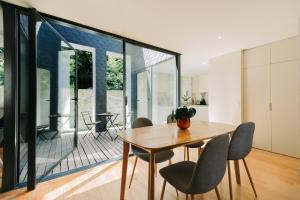 a dining room with a wooden table and chairs at Aparthotel Oporto Palace in Porto