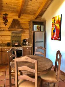 a wooden kitchen with a wooden table and chairs at Bosques de Monterreal in Mesa de las Tablas