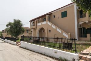 a building with a fence next to a street at Euphoria complex in Kavos