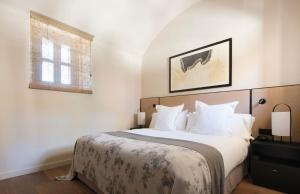 a bedroom with a large bed and a window at Can Ferrereta in Santanyi