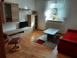 a living room with a table and a couch at Apartment - Ferienwohnung 1 Treffen am Ossiachersee in Treffen