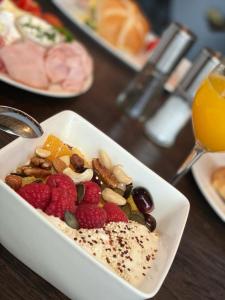 een witte schaal met fruit en noten op een tafel bij Hotel Victoria - adults only in Gerlos
