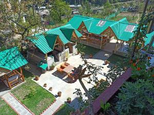 an aerial view of a house with green roofs at Purnima Guest House in Manāli