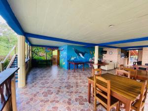 a dining room with blue walls and a table at Ecolodge Mar y Rio in Nuquí