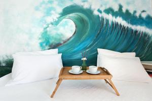 a bedroom with a large painting of a wave at Corfu Amboti Apt in Glyfada