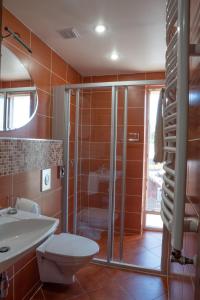 a bathroom with a shower and a toilet and a sink at Plytu 9 apartment in Palanga