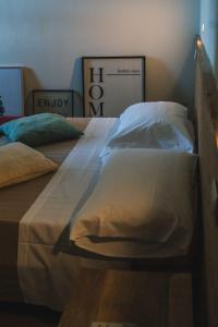 a bed with two pillows on top of it at Podere Castellare in Pelago