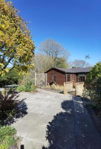 a house with a driveway in front of it at The Garden Lodge in Llynclys