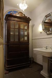a bathroom with a wooden cabinet and a sink at Studio Rempart in Brussels