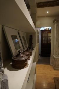 a row of vases on a shelf in a hallway at Studio Rempart in Brussels