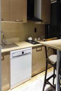 a kitchen with a white dishwasher next to a counter at Home Of Istanbul in Istanbul