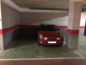 un pequeño coche rojo estacionado en un garaje en Playa Pacífico Apartment en Málaga