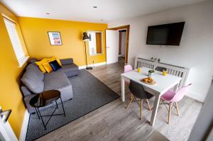 a living room with a couch and a table at Brighton Holiday Village PARKING AVAILABLE in Brighton & Hove