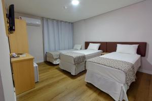 Postel nebo postele na pokoji v ubytování Fênix Hotel Bom Retiro