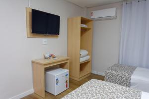 Postel nebo postele na pokoji v ubytování Fênix Hotel Bom Retiro
