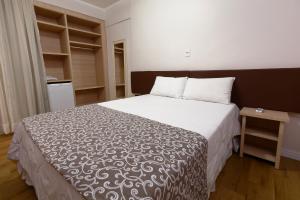 Postel nebo postele na pokoji v ubytování Fênix Hotel Bom Retiro