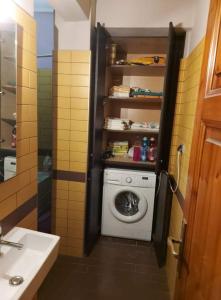 a bathroom with a washing machine and a sink at Villa Zisi in Livadáki