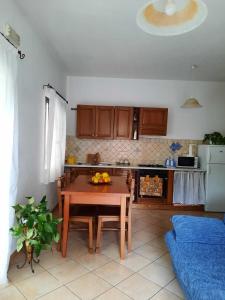 a kitchen with a table with fruit on it at Domo Vèdele in Galtellì