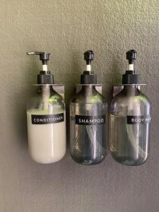 three bottles of detergent sitting on a wall at Highlands Resort in Guerneville