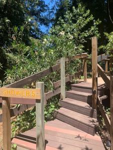 a wooden boardwalk with a sign that says showers at Highlands Resort in Guerneville