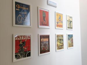 a group of posters on a wall at BIKEINN in Vouzela