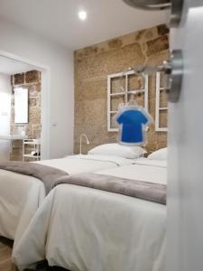 a room with four beds and a blue chair at BIKEINN in Vouzela