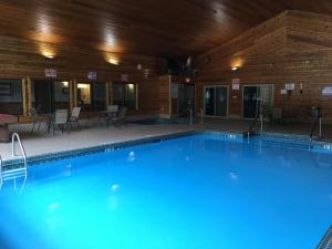 a large swimming pool in a large room at Rustic Manor in Saint Germain